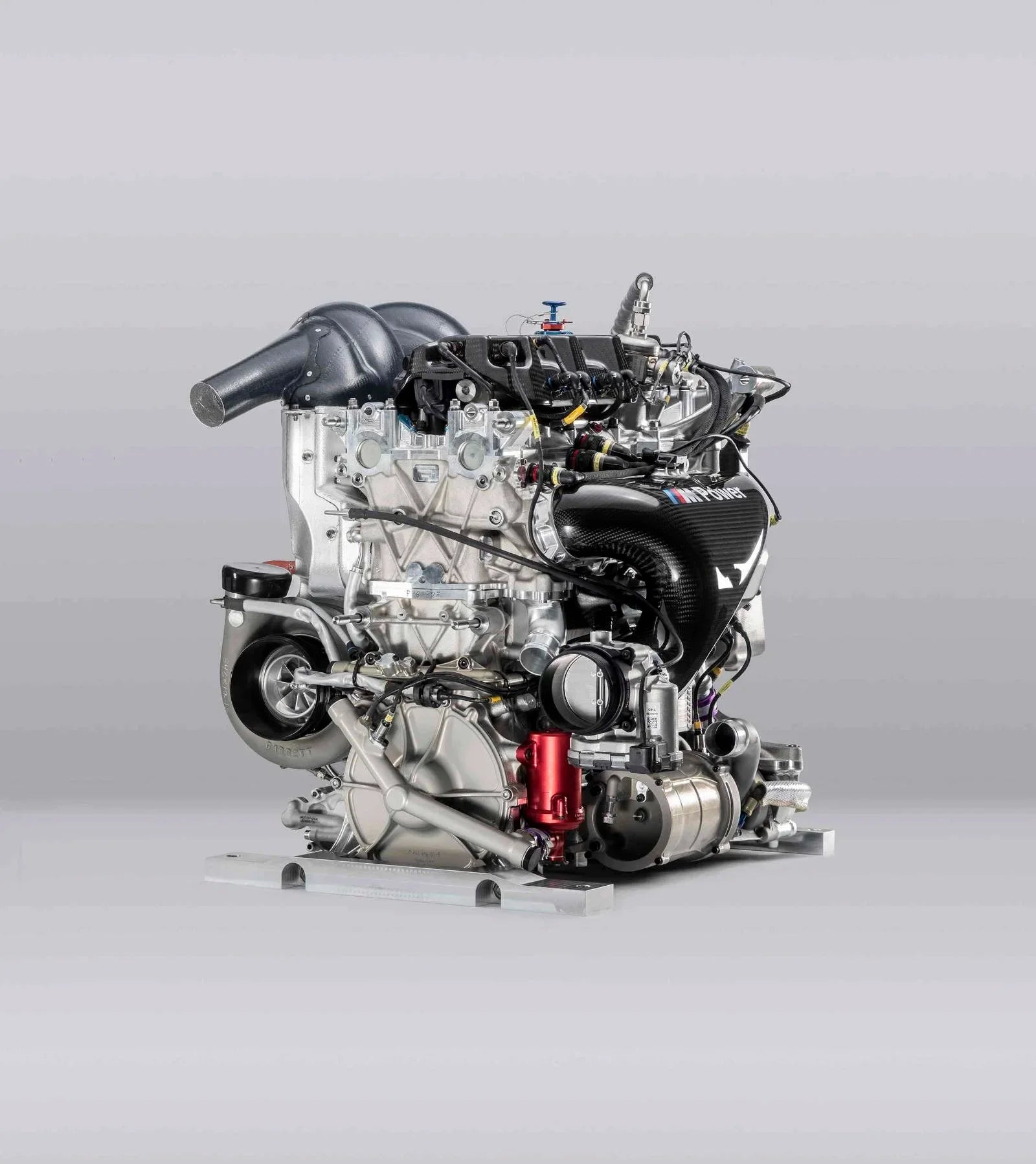 Turbocharged BMW M Power race engine three-quarter view with turbo and intake plenum